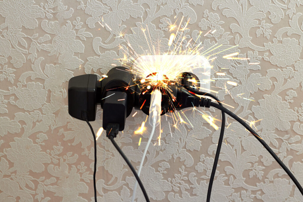 Overloaded socket, spark. Danger of electric shock, fire. Wire, plug, fire.